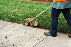 Person using a lawn edging tool