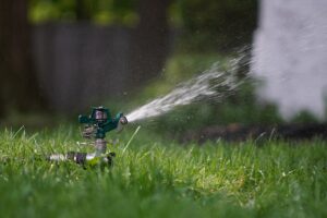 A sprinkler spraying water over a lawn