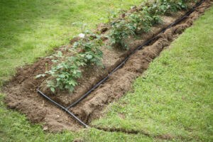 Drip hose system installed into flowerbed