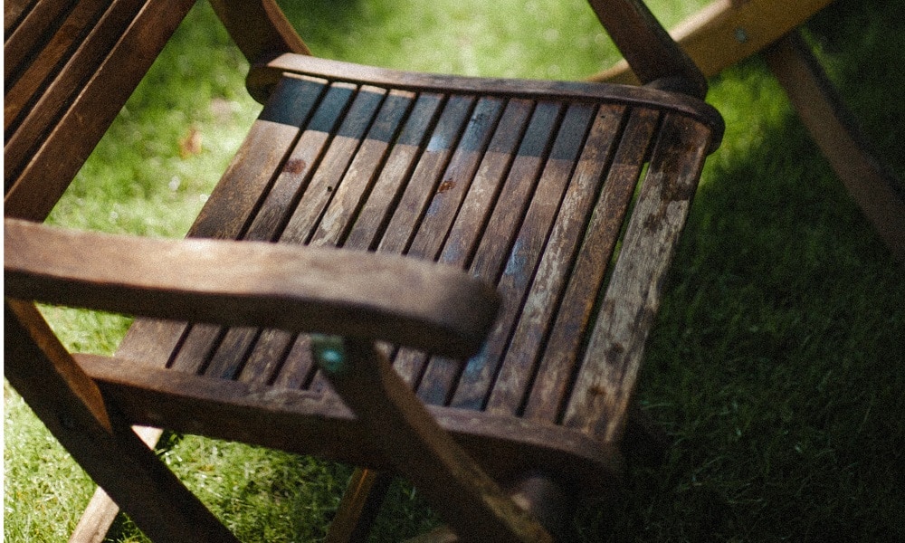 A weathered a worn garden chair